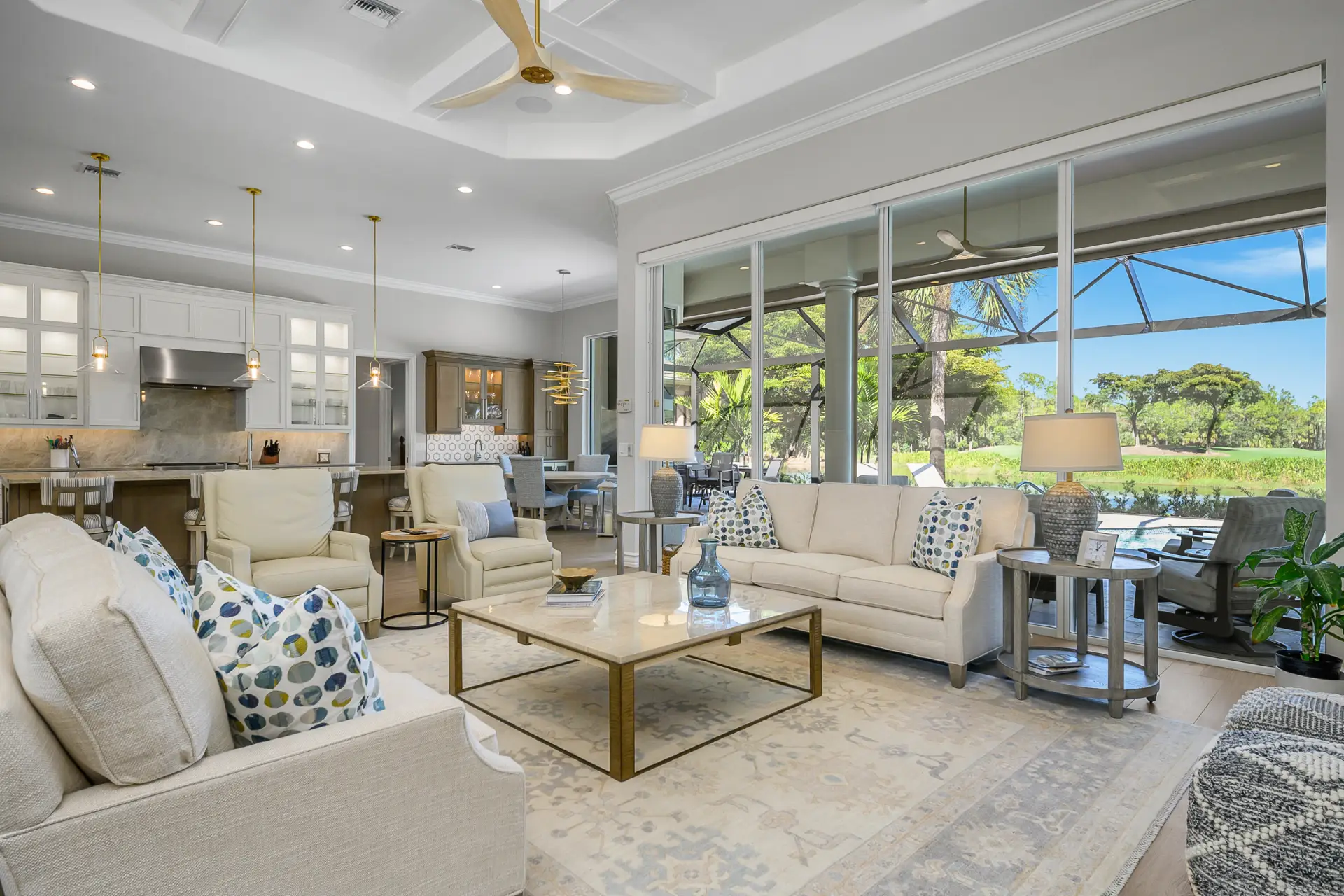 A cozy living room featuring a ceiling fan and a large window allowing natural light to fill the space.