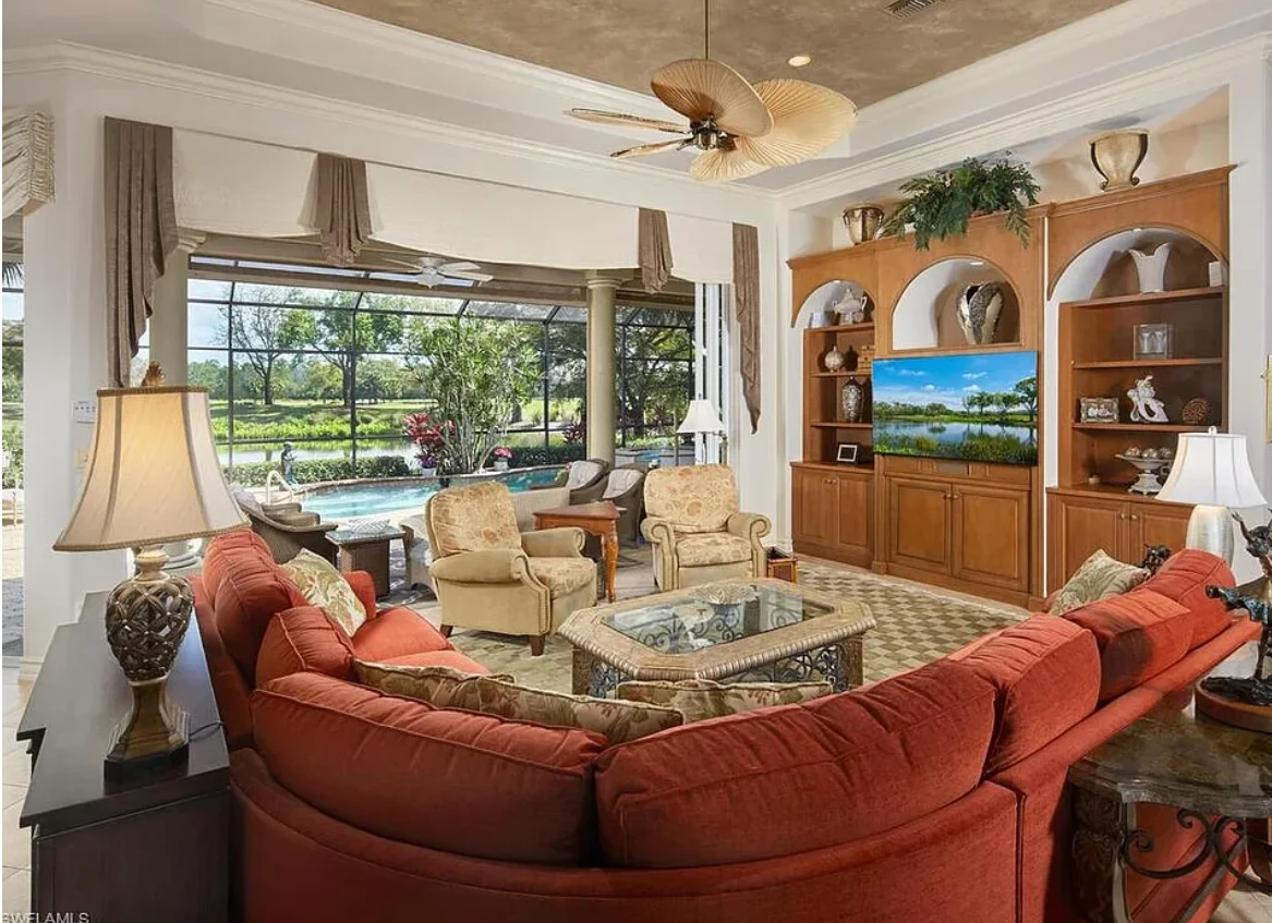 A cozy living room featuring a large screen television and comfortable couches arranged for relaxation and entertainment.